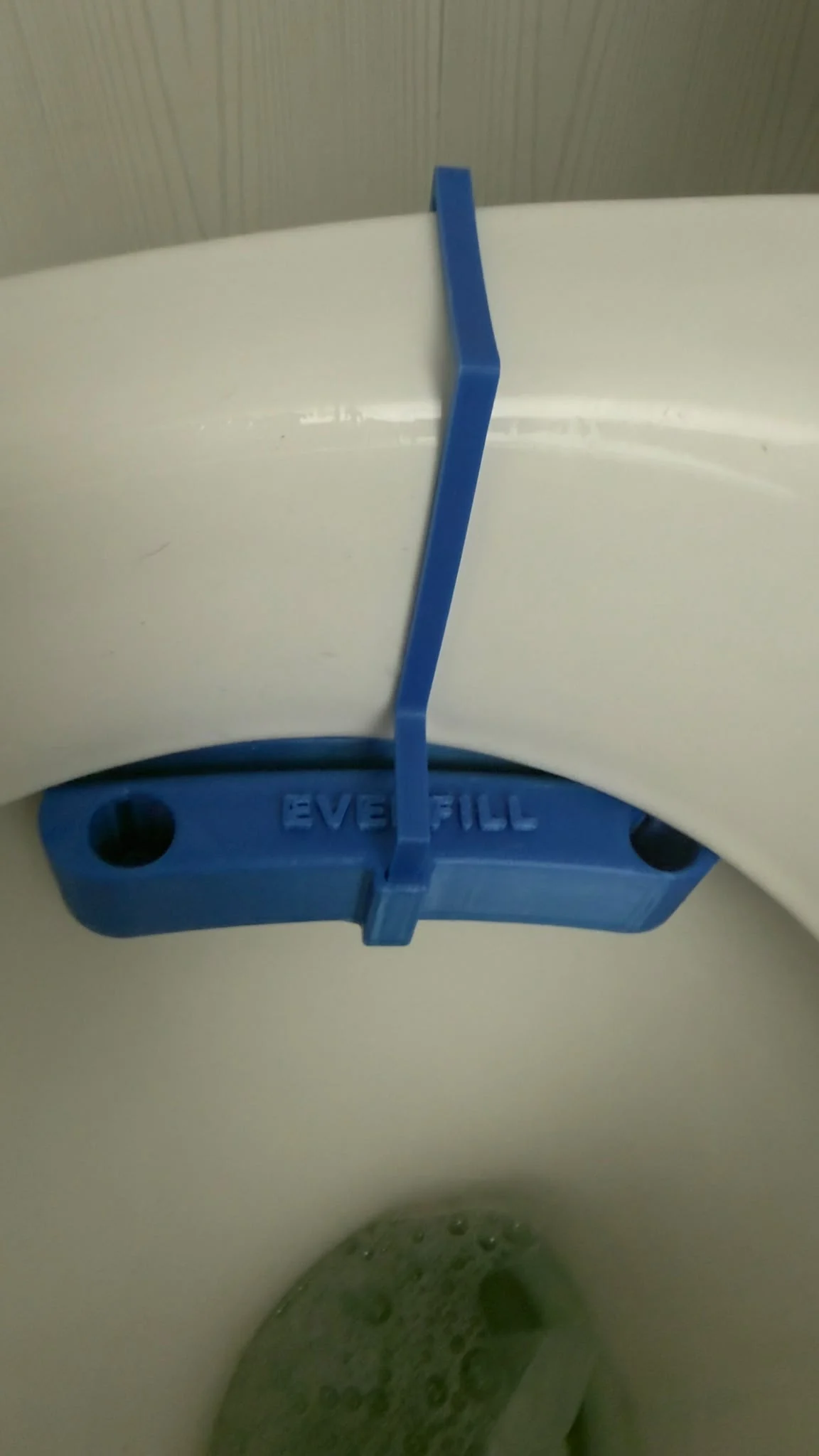 Blue EverFill dispenser fitted beneath a toilet rim